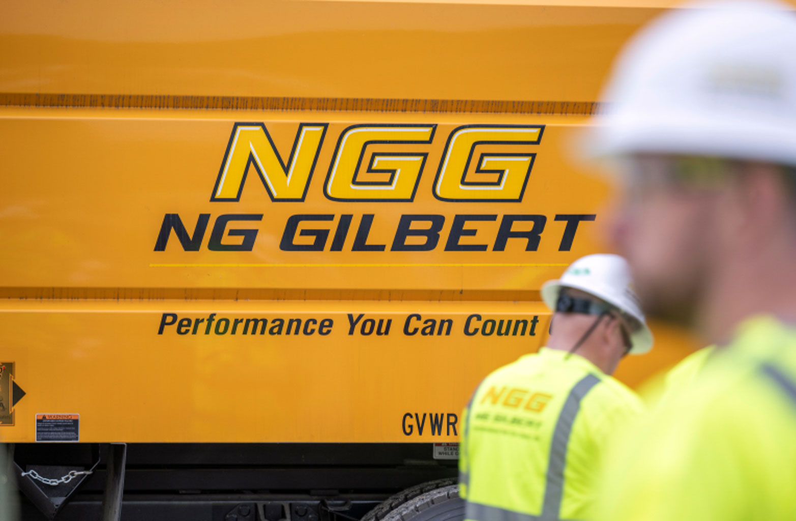 A close-up of the NG Gilbert logo on a truck.
