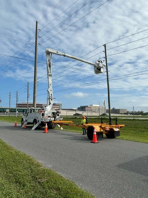 A lineman working to replace a damaged pole.